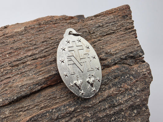 Sterling silver Miraculous Medal pendant — oval with engraved Virgin Mary figure and the prayer text around the border, bail included