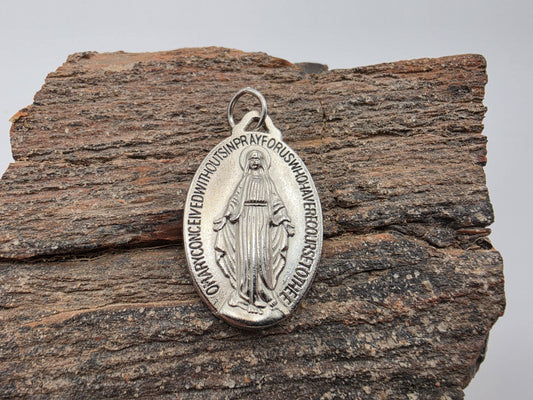 Sterling silver Miraculous Medal pendant — oval with engraved Virgin Mary figure and the prayer text around the border, bail included